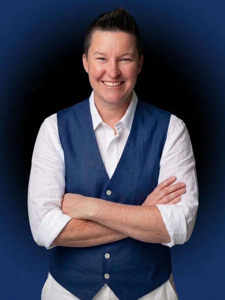 Michelle Horridge, founder of Fortitude of Valor Consulting, standing with arms folded in a navy waistcoat